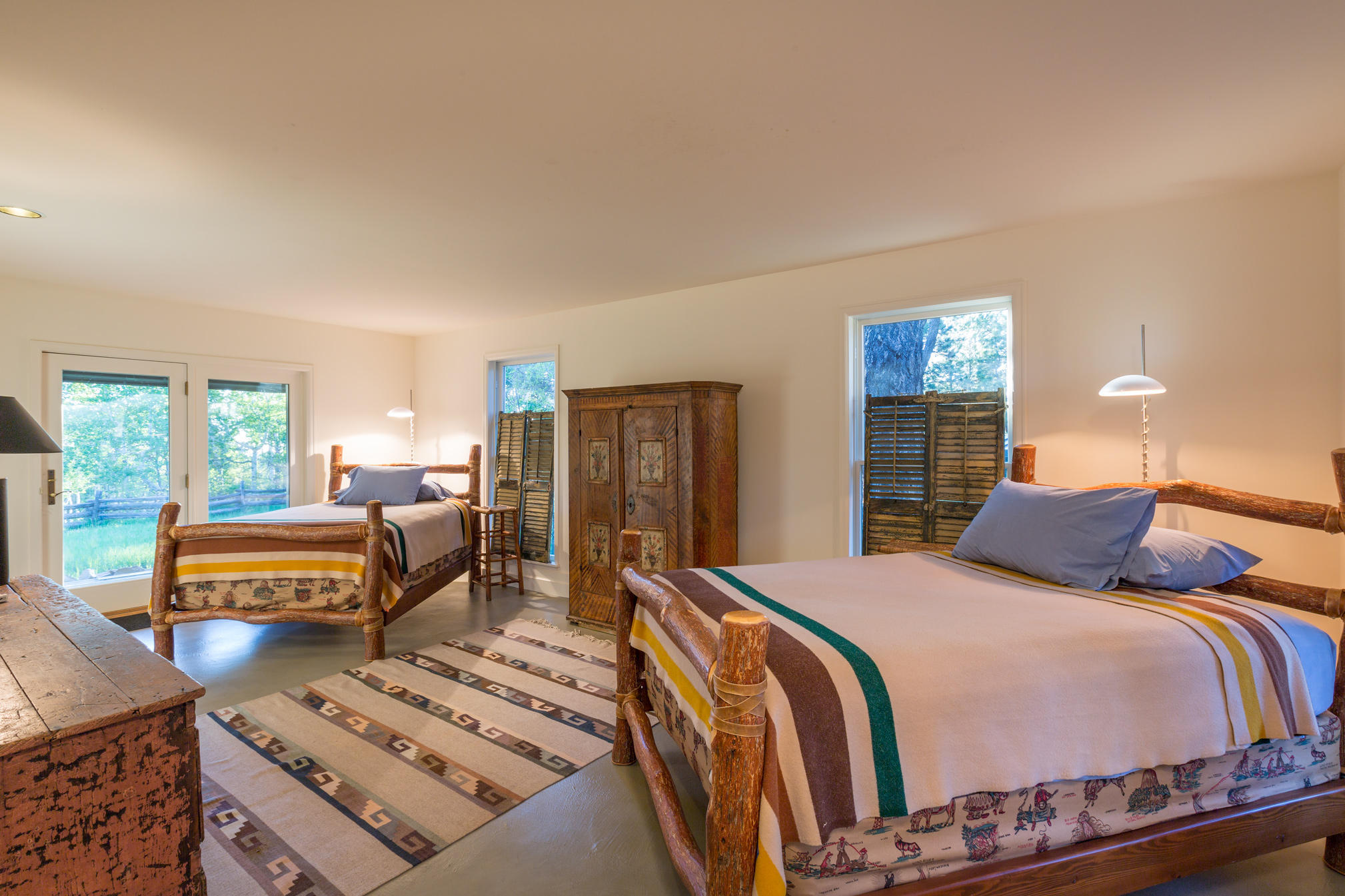 3289 Laughing Dog Road Placerville, CO 81430 - Photo 30 of 52 a bedroom with a bed a dresser and potted plants