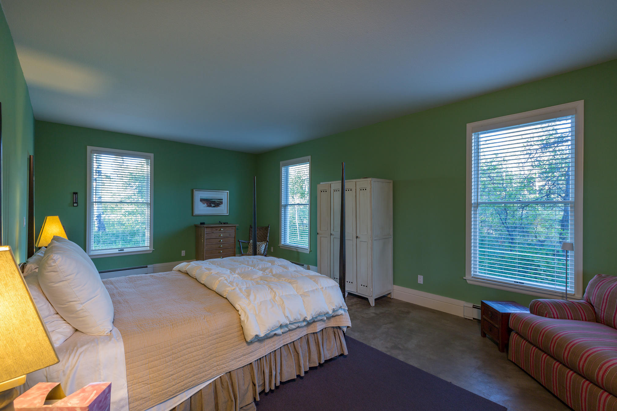 3289 Laughing Dog Road Placerville, CO 81430 - Photo 39 of 52 a bedroom with a bed couch and windows