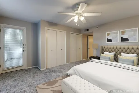 a spacious bedroom with a large bed a chandelier and closet