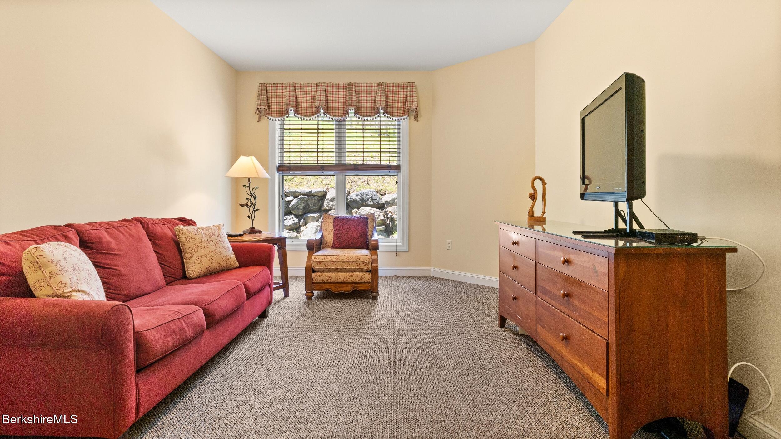 14 Alpine Trail, Unit 14 Pittsfield, MA 01201 - Photo 13 of 29 a living room with furniture and a window