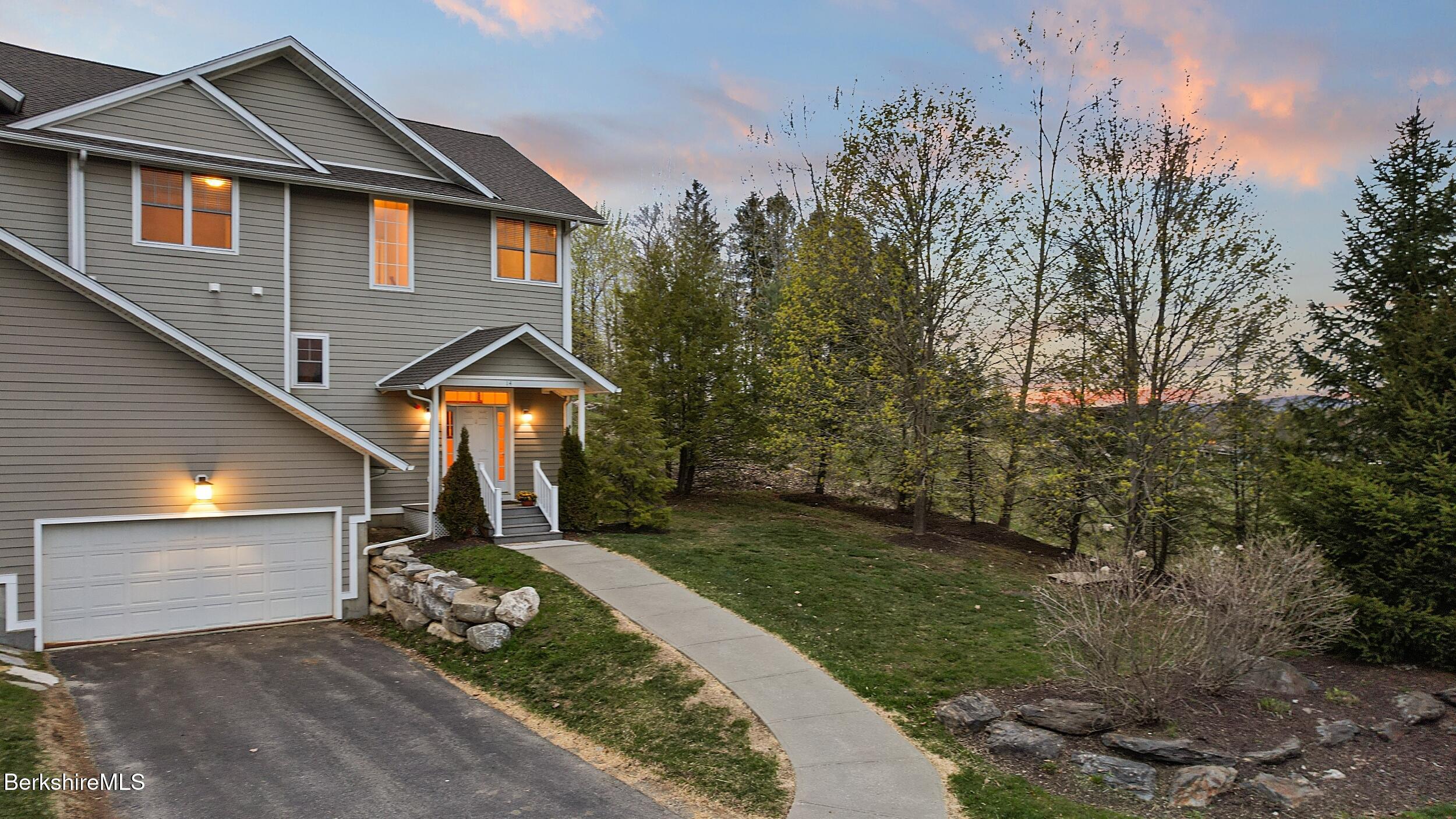 14 Alpine Trail, Unit 14 Pittsfield, MA 01201 - Photo 3 of 29 a front view of a house with a yard and garage