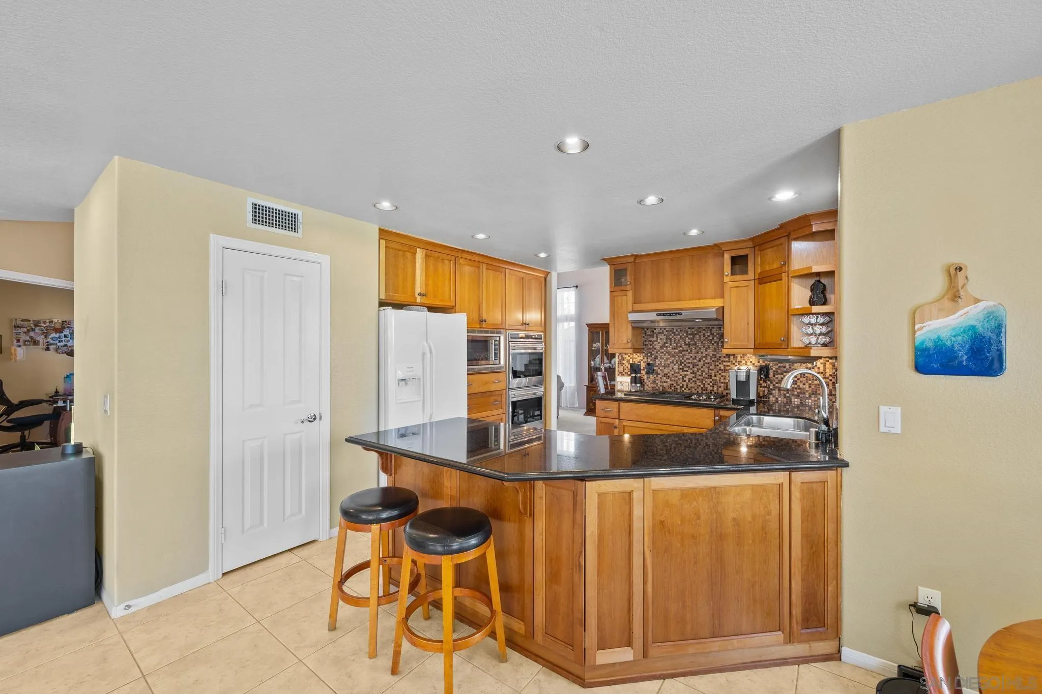 13628 Sunset View Road Poway, CA 92064 - Photo 17 of 70 a dining room with stainless steel appliances granite countertop furniture and a kitchen view