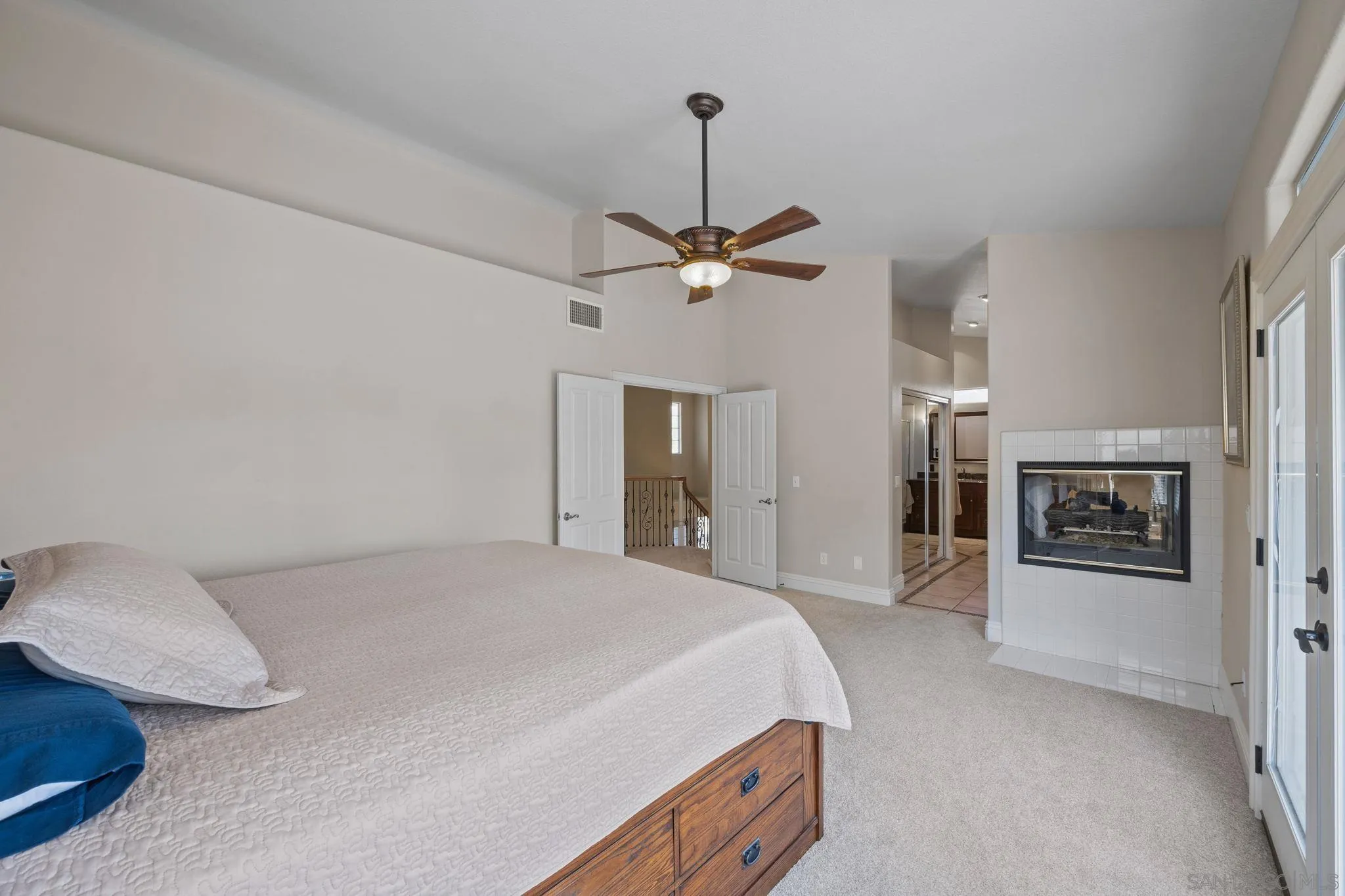 13628 Sunset View Road Poway, CA 92064 - Photo 33 of 70 a bedroom with a bed and a chandelier