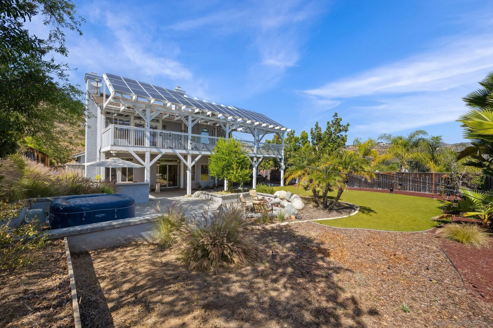 13628 Sunset View Road Poway, CA 92064 - Photo 54 of 70 a view of a house with a yard and a garden
