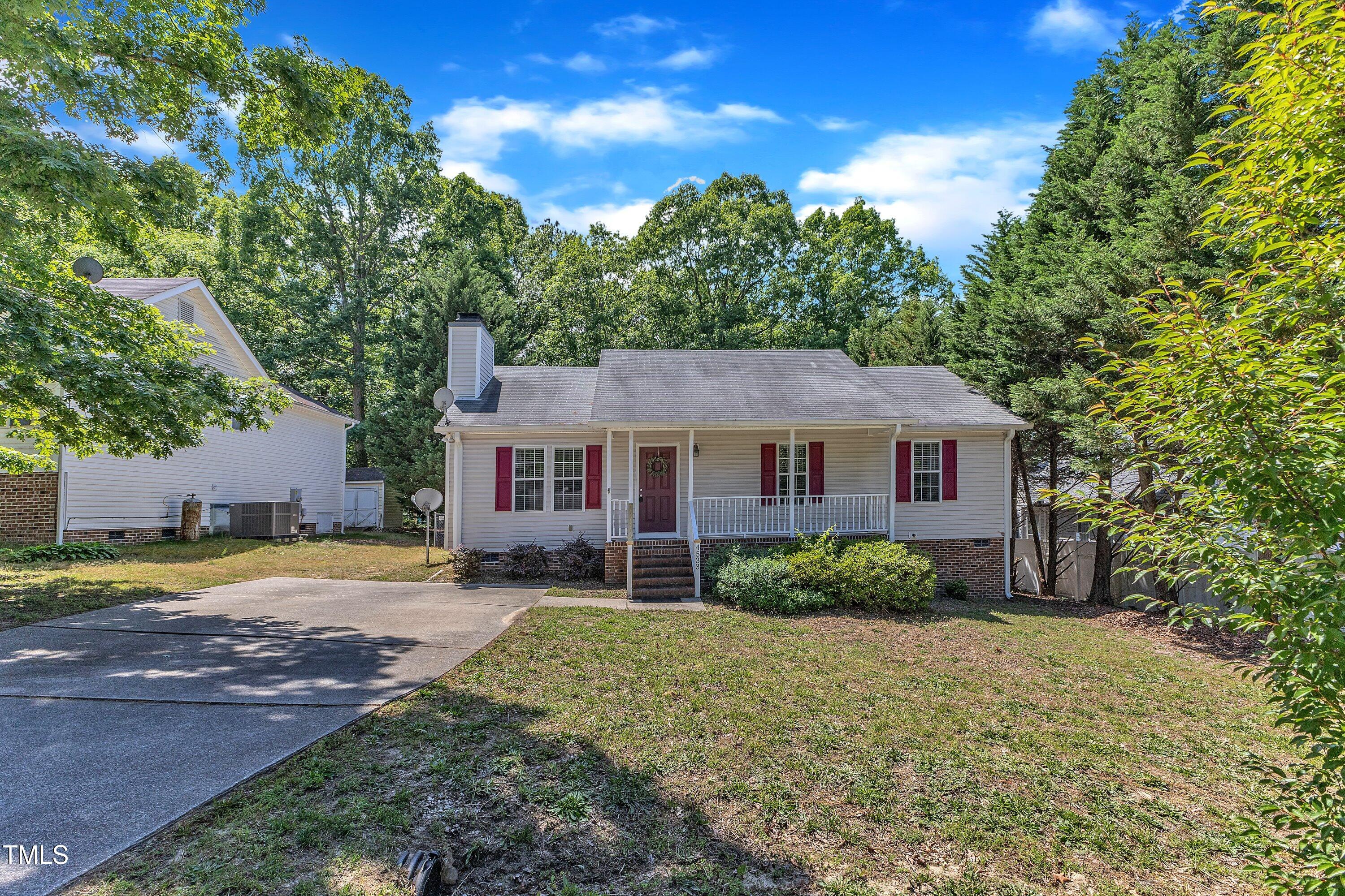 4533 Whistling Way Raleigh, NC 27616 - Photo 1 of 25 a view of a big house with a big yard and large trees