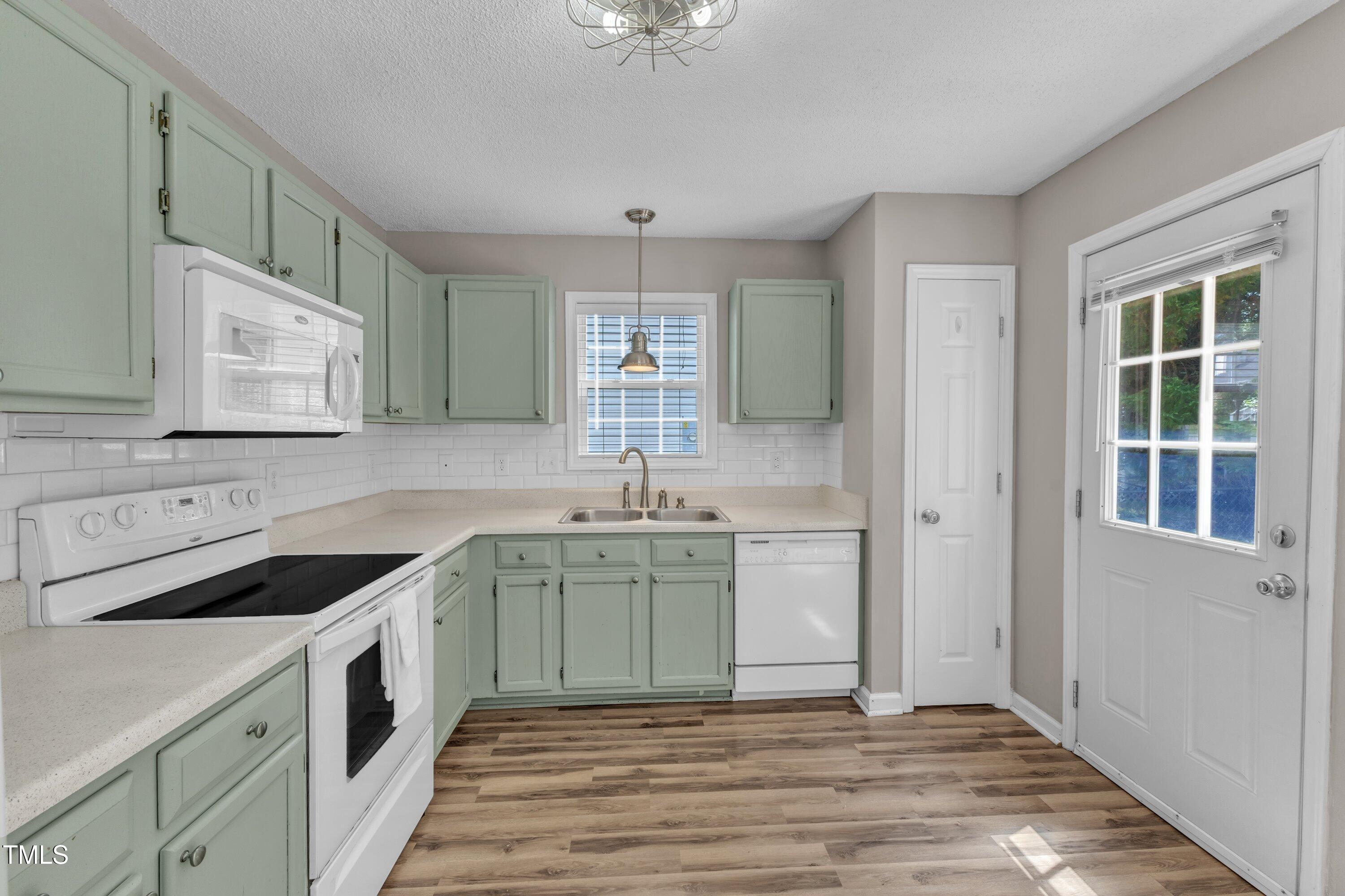 4533 Whistling Way Raleigh, NC 27616 - Photo 11 of 25 a kitchen with a sink stove and cabinets