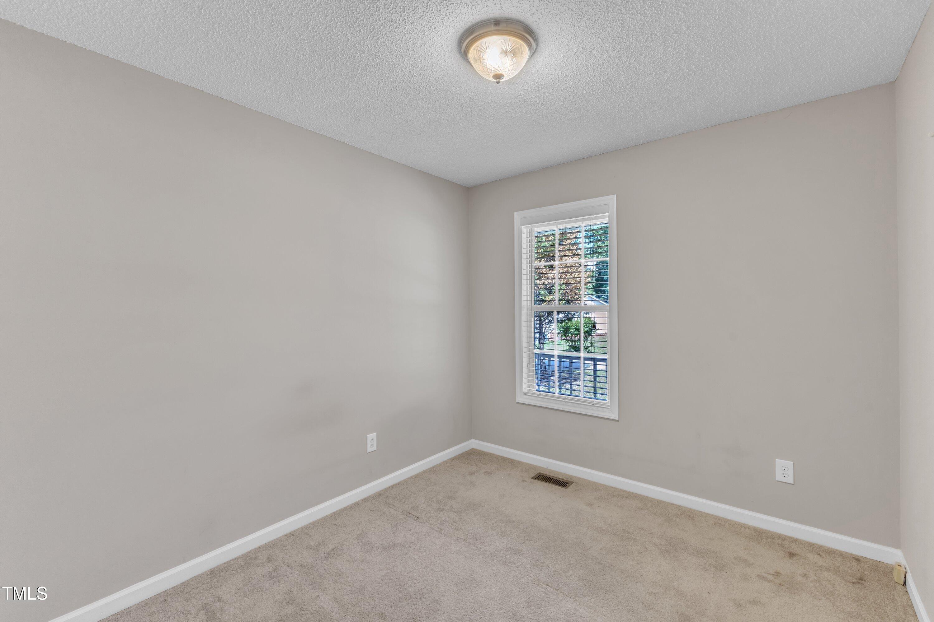 4533 Whistling Way Raleigh, NC 27616 - Photo 13 of 25 an empty room with windows
