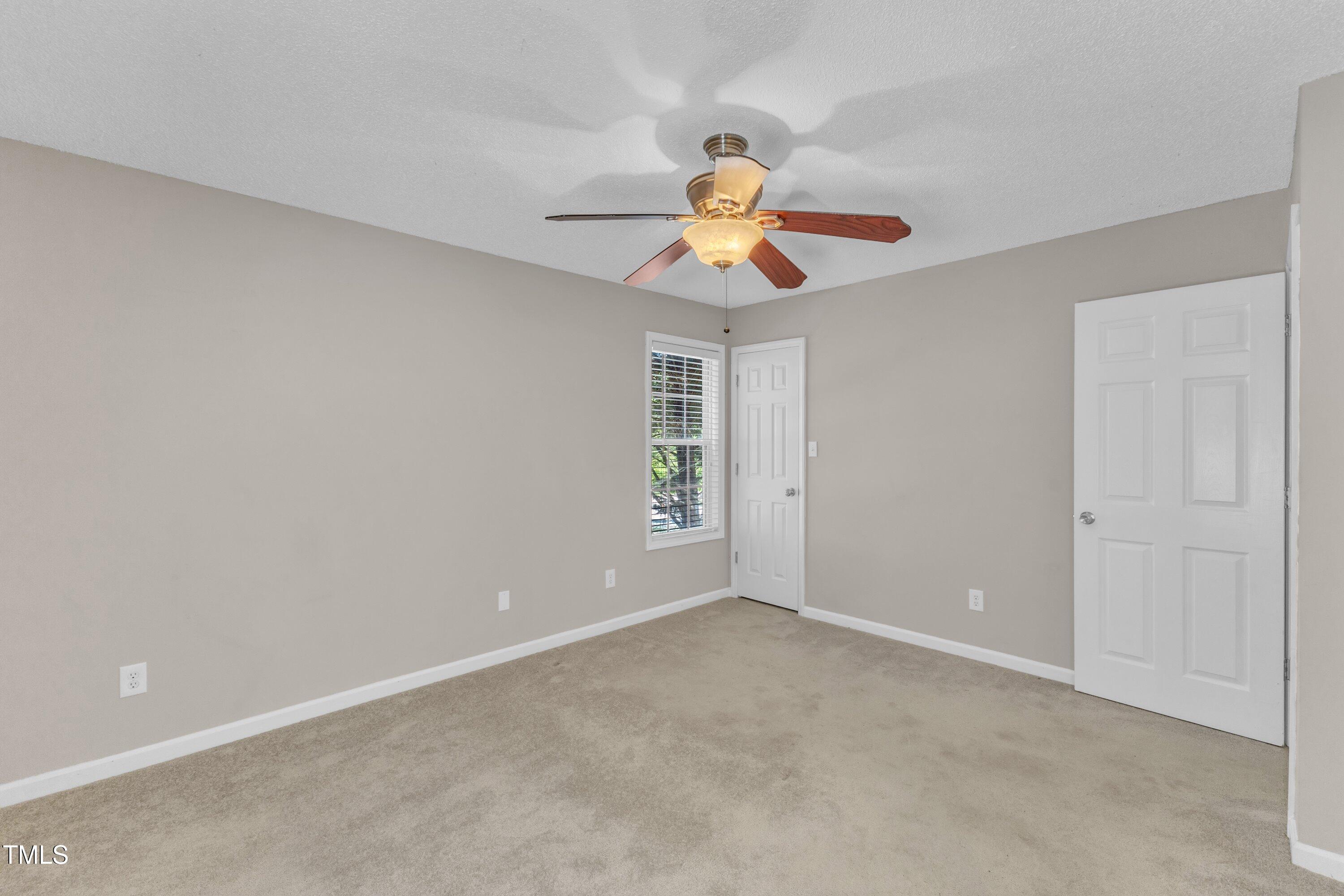 4533 Whistling Way Raleigh, NC 27616 - Photo 20 of 25 a view of an empty room with window and chandelier fan