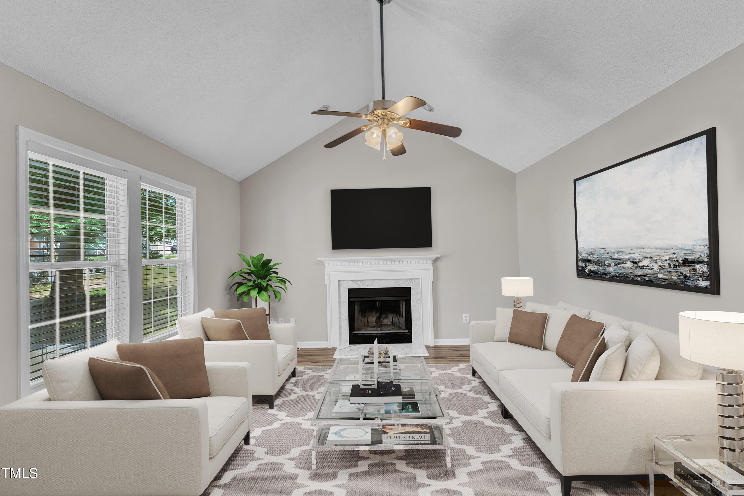 4533 Whistling Way Raleigh, NC 27616 - Photo 4 of 25 a living room with furniture a fireplace and a flat screen tv