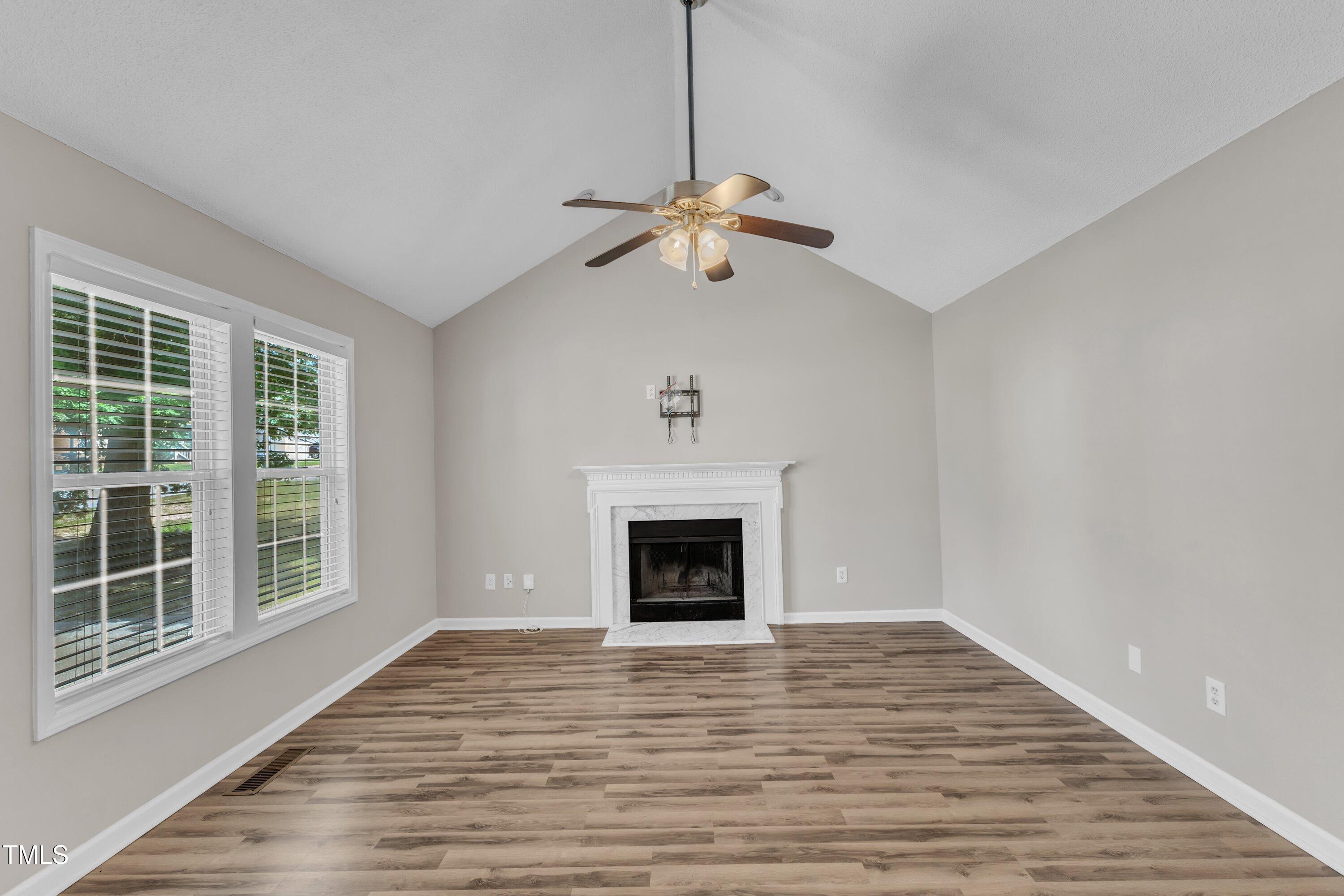 4533 Whistling Way Raleigh, NC 27616 - Photo 5 of 25 a view of empty room with wooden floor and fan