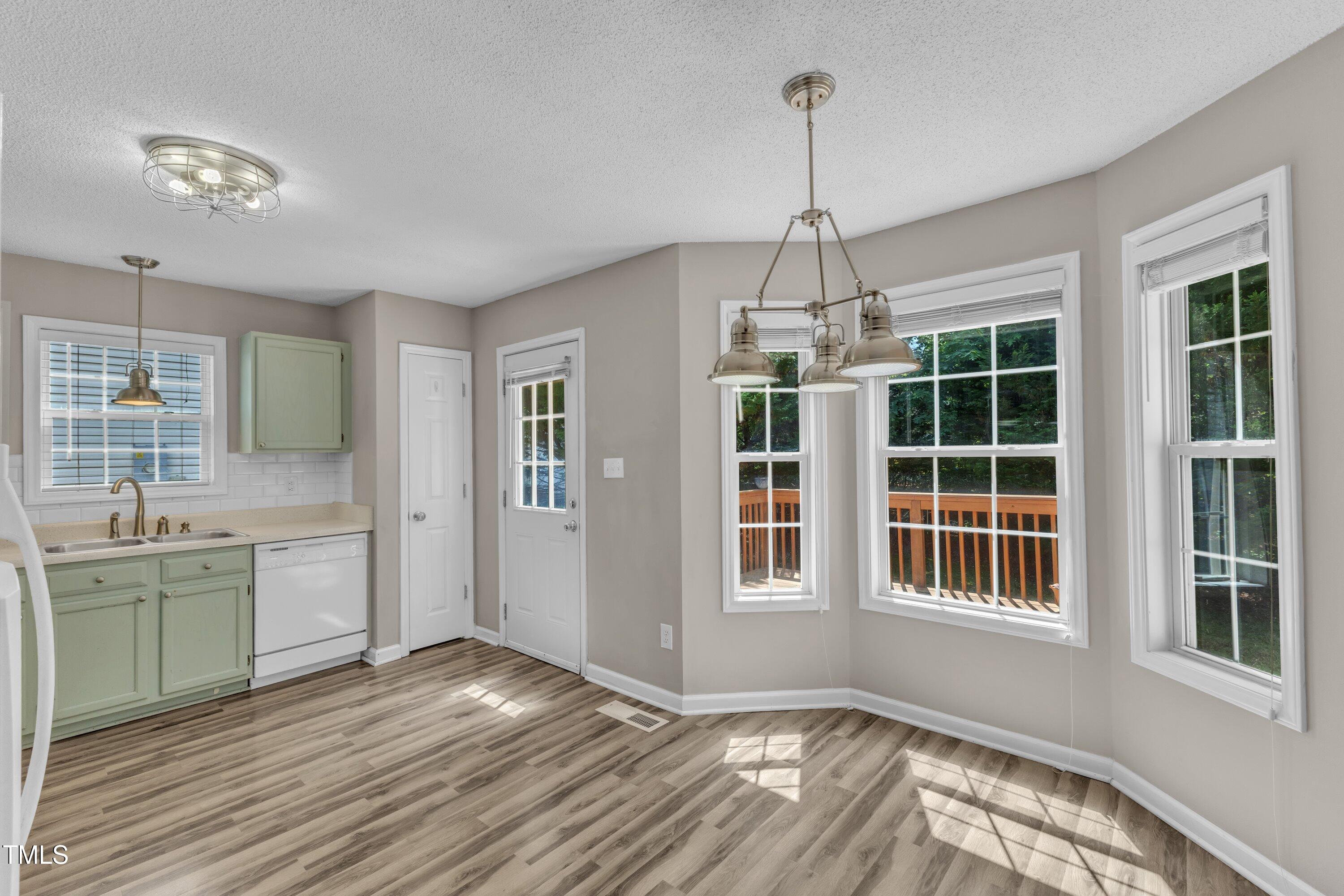 4533 Whistling Way Raleigh, NC 27616 - Photo 7 of 25 a view of an empty room with window and wooden floor
