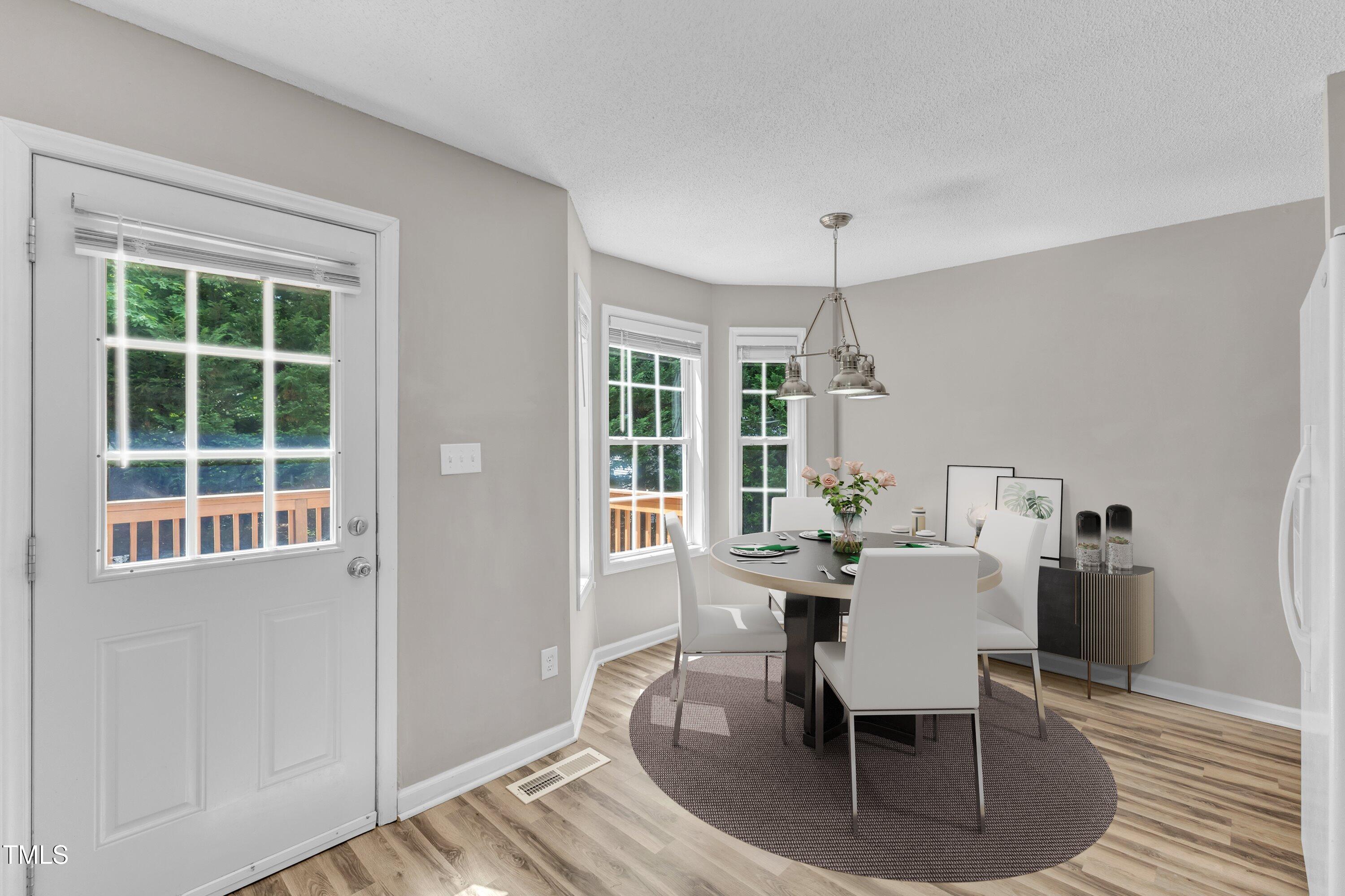 4533 Whistling Way Raleigh, NC 27616 - Photo 8 of 25 a dining room with furniture window and wooden floor