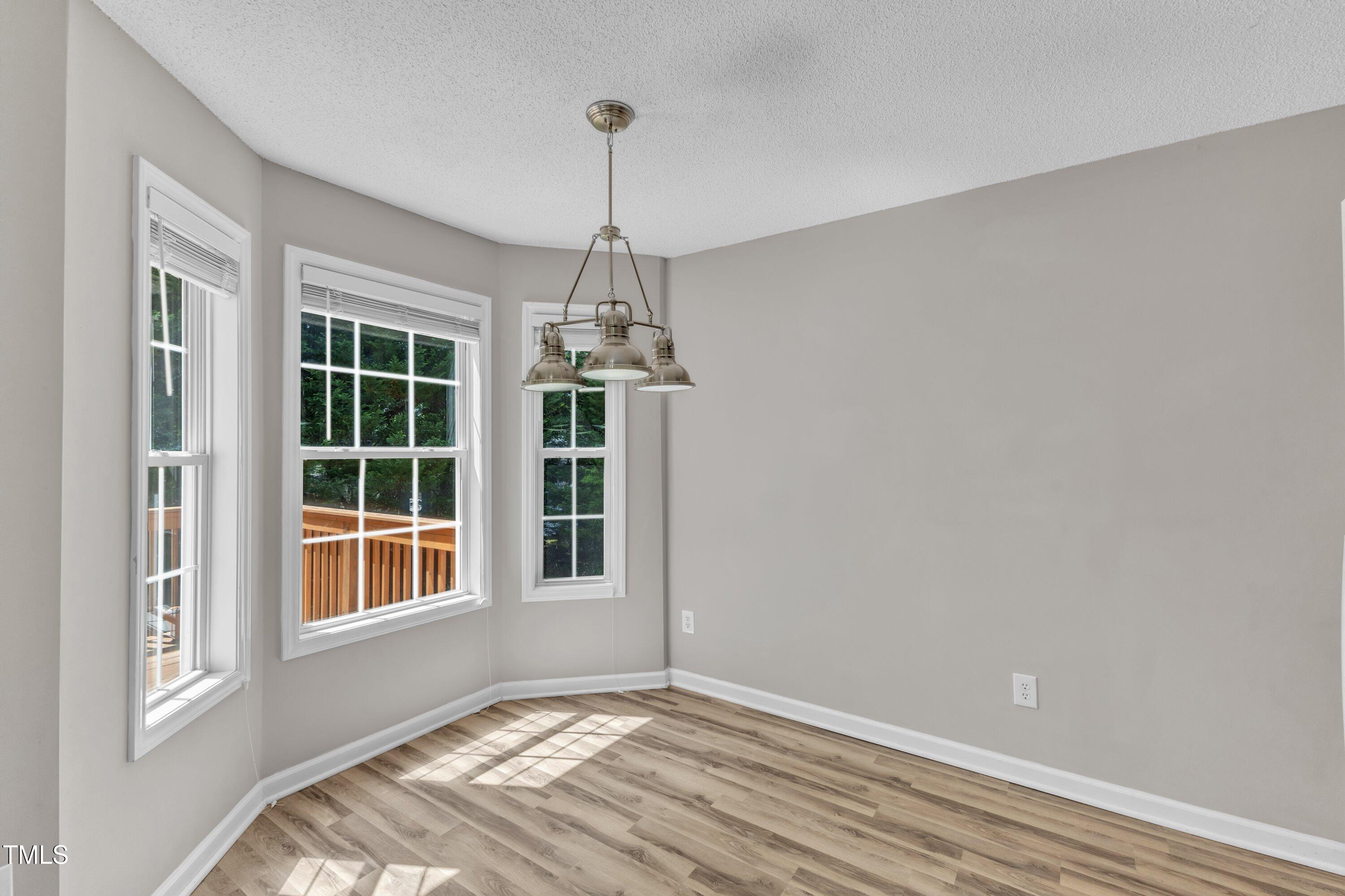 4533 Whistling Way Raleigh, NC 27616 - Photo 9 of 25 a view of empty room with windows