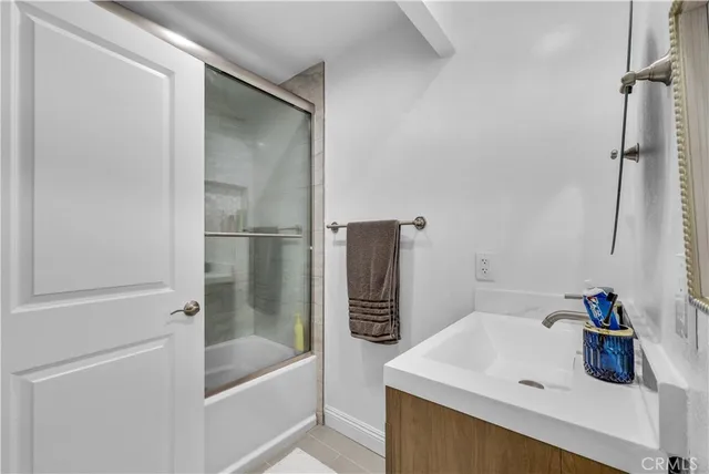 a bathroom with a double vanity sink toilet and shower