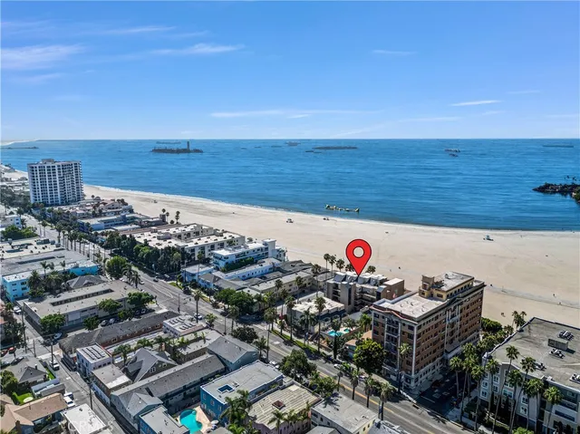 a front view of a building with streets and trees