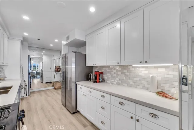a kitchen with a stove a sink and a refrigerator