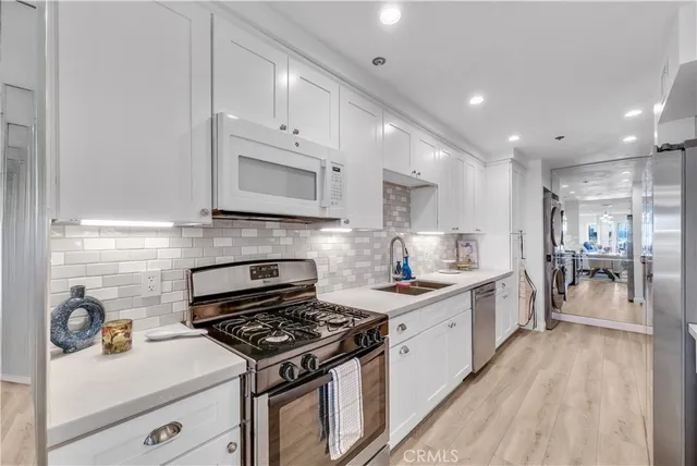 a utility room with sink dryer and washer