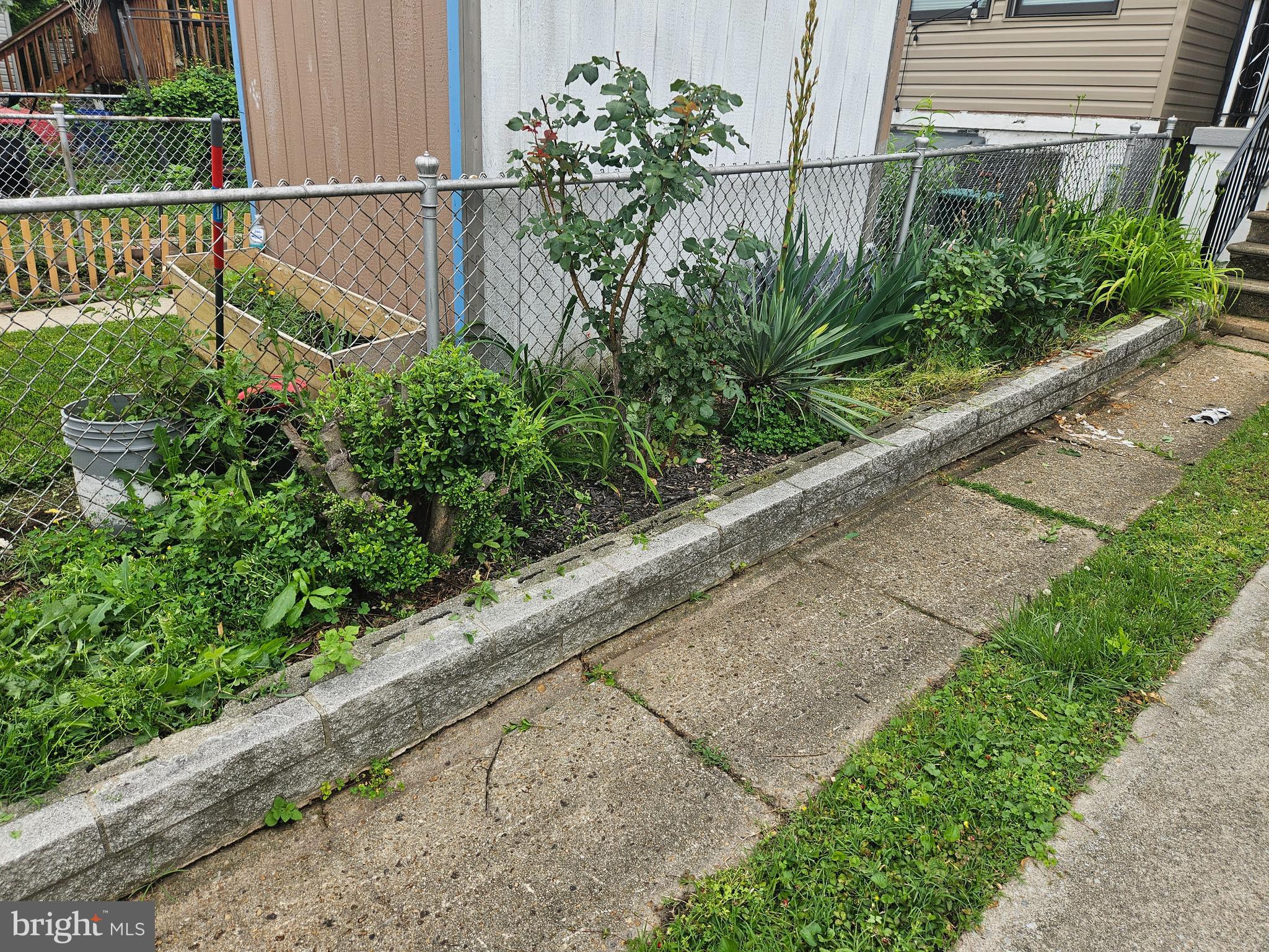 6907 Belclare Road Baltimore, MD 21222 - Photo 18 of 26 a view of a garden with a chair