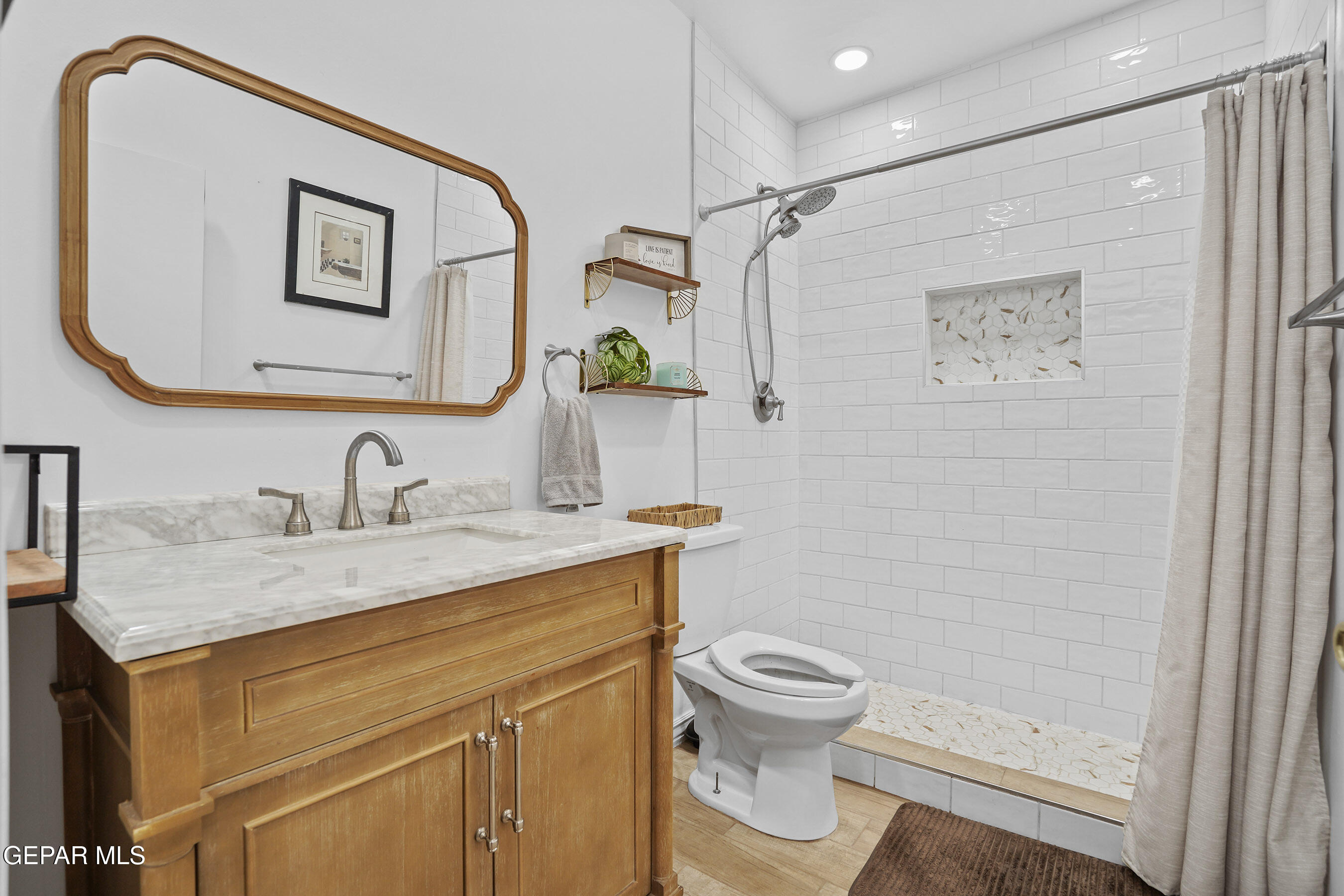 146 Croom Road El Paso, TX 79915 - Photo 38 of 54 a bathroom with a granite countertop sink mirror vanity and toilet