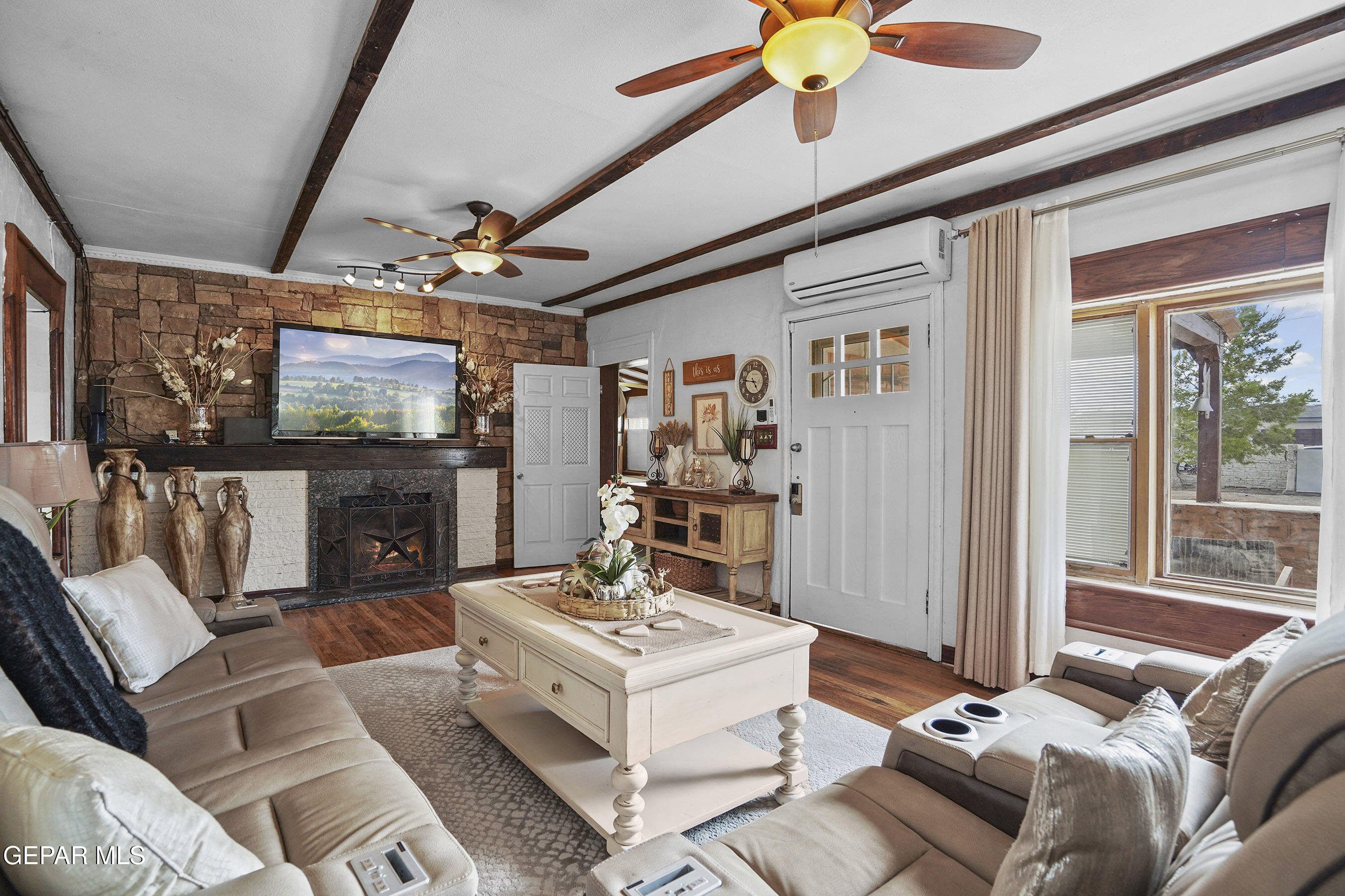 146 Croom Road El Paso, TX 79915 - Photo 8 of 54 a living room with furniture a flat screen tv and a fireplace