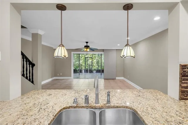 a view of a kitchen center island with stainless steel appliances granite countertop living room