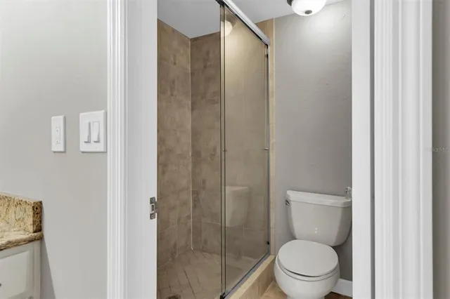 a bathroom with a toilet a sink and shower