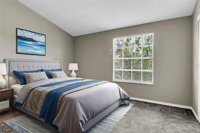 a bedroom with a bed and a window