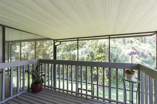 a view of a balcony with wooden floor