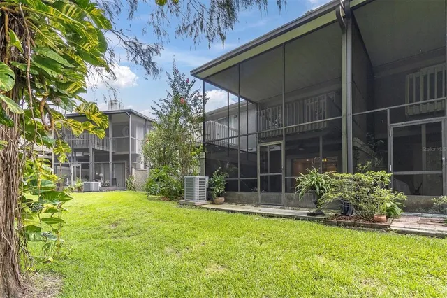 a view of a house with a yard and sitting area