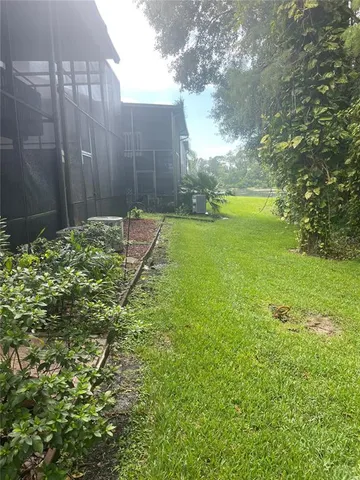 a backyard of a house with a yard and outdoor seating