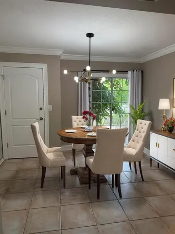 a outdoor dining space with furniture and window