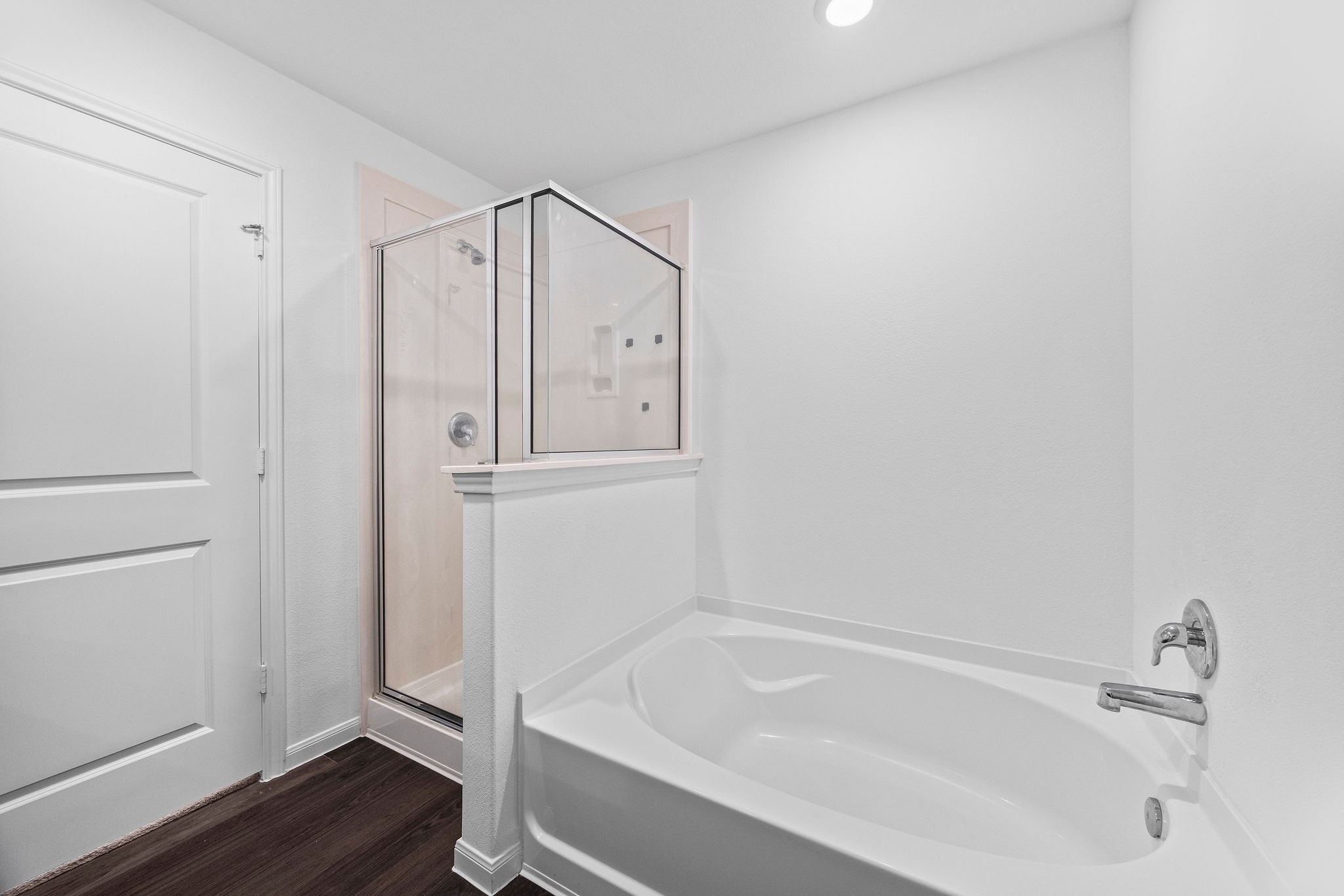 23334 Simmental Road Hockley, TX 77447 - Photo 18 of 38 Relax in this spa-like primary bath featuring a deep soaking tub, sleek walk-in shower for a peaceful retreat.