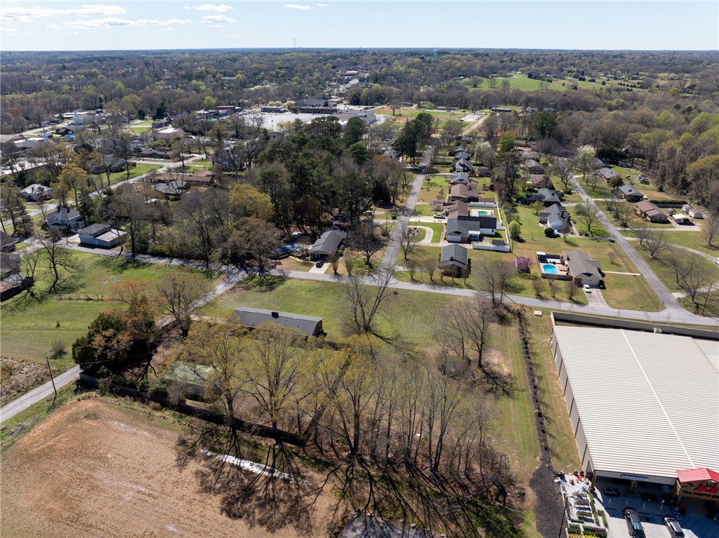 300 Green Street Williamston, SC 29697 - Photo 38 of 47 An aerial perspective reveals a vibrant neighborhood with residential homes and lush greenery.