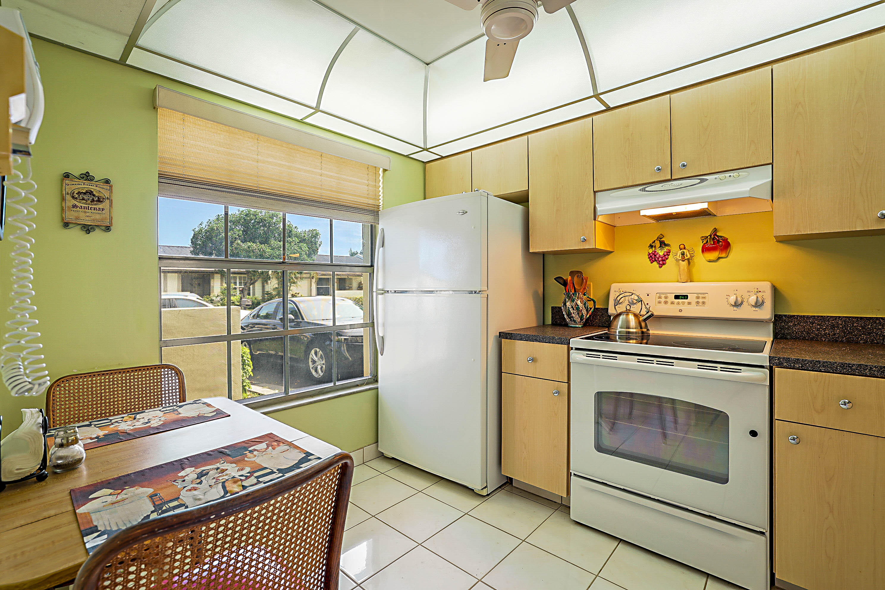 5231 Copperleaf Circle Delray Beach, FL 33484 - Photo 13 of 31 a kitchen with stainless steel appliances granite countertop a refrigerator and a stove top oven