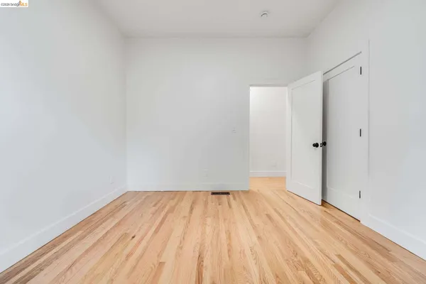 a view of room with wooden floor and white walls