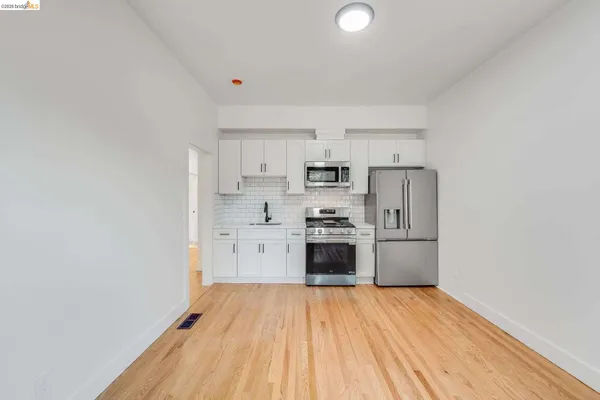 a kitchen with stainless steel appliances a refrigerator and a stove top oven