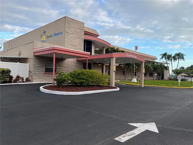 a view of a terrace with lawn chairs
