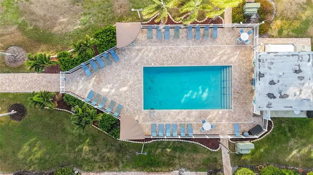 a view of a hallway with wooden floor and a living room