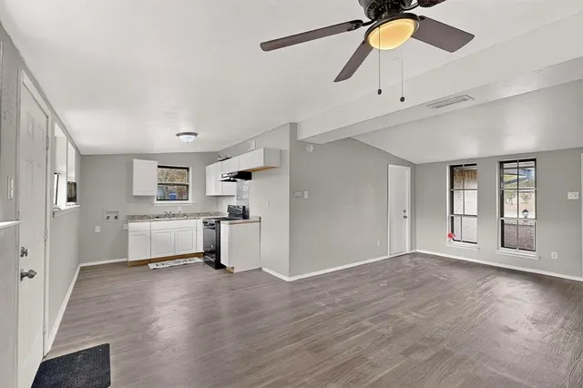 a view of a kitchen with a sink and a window