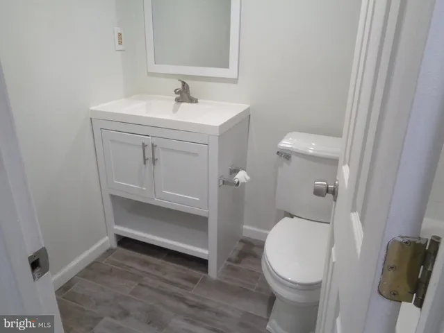 a white toilet sitting next to a bath tub