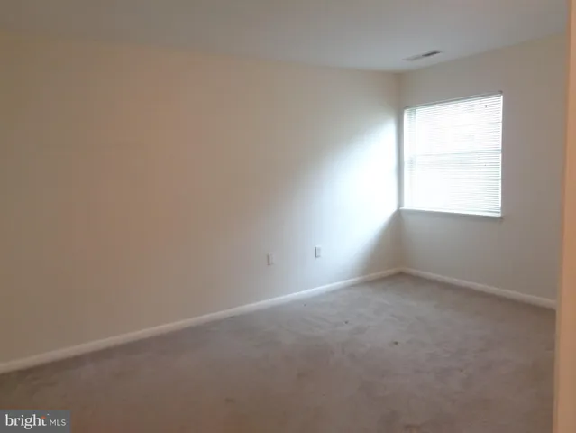 a view of an empty room and closet area