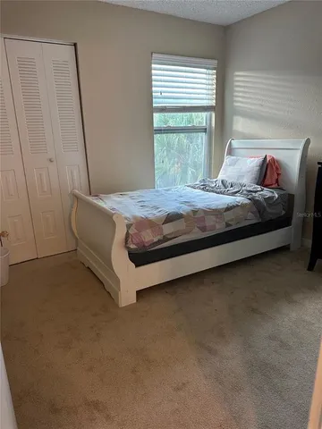 a bedroom with a bed and window