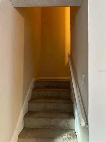 a view of staircase with white walls