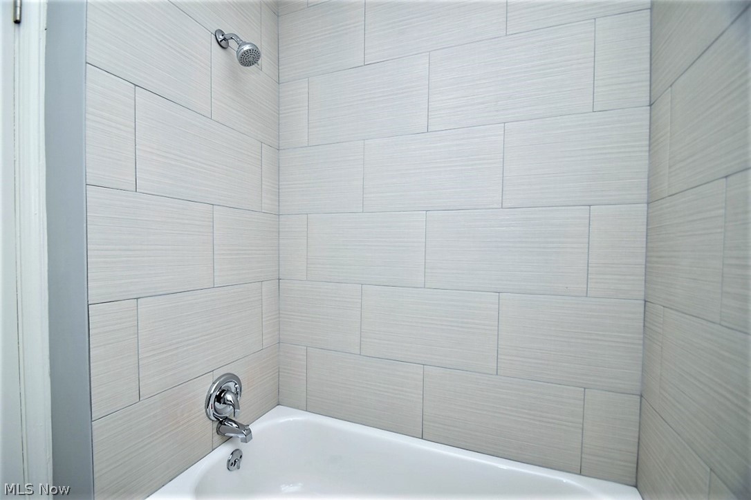 21012 Hansen Road Maple Heights, OH 44137 - Photo 14 of 28 The full bath on the first floor has a tub/shower with a tiled surround