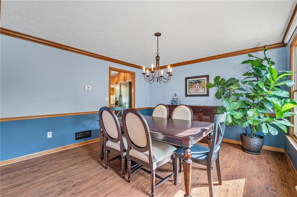 122 Rippling Brook Drive Sewickley, PA 15143 - Photo 11 of 31 a dining room with furniture potted plants and wooden floor
