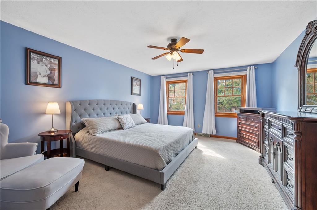 122 Rippling Brook Drive Sewickley, PA 15143 - Photo 15 of 31 a spacious bedroom with a bed a couch and windows
