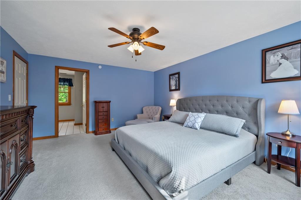 122 Rippling Brook Drive Sewickley, PA 15143 - Photo 16 of 31 a bedroom with a bed and a chandelier