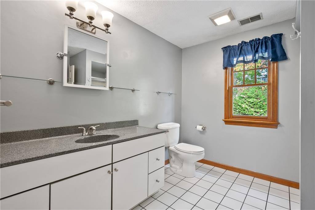 122 Rippling Brook Drive Sewickley, PA 15143 - Photo 17 of 31 a bathroom with a sink a toilet and a mirror