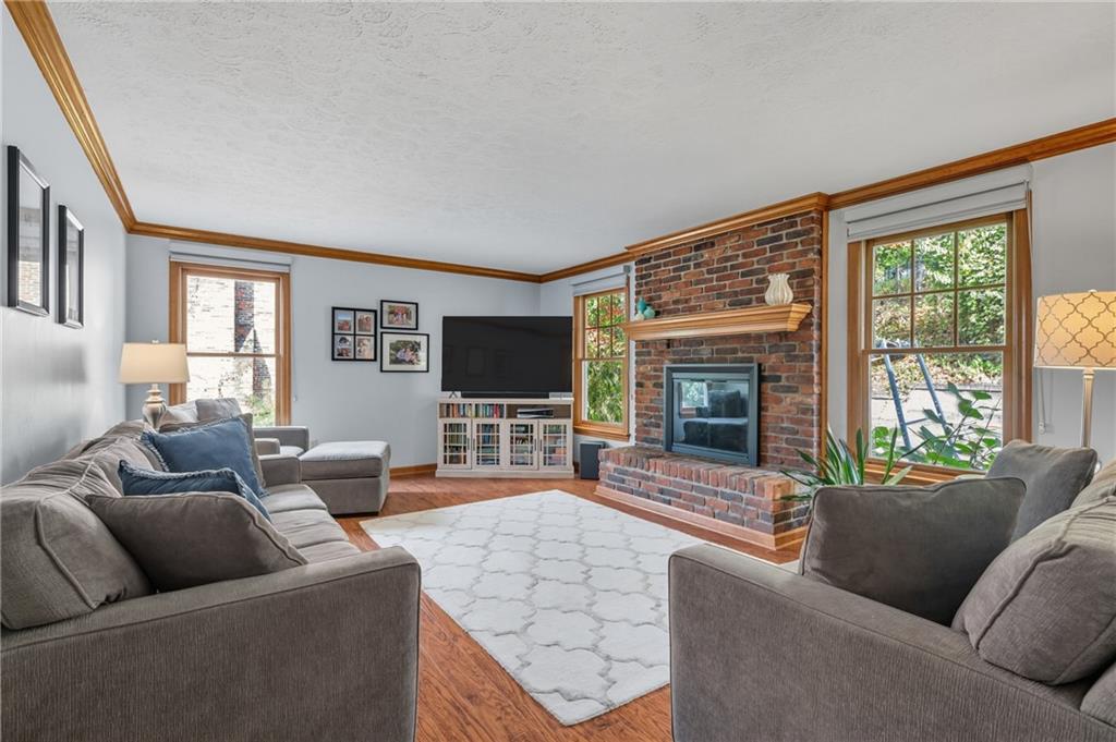 122 Rippling Brook Drive Sewickley, PA 15143 - Photo 2 of 31 a living room with furniture large window and a flat screen tv