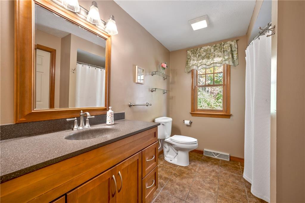 122 Rippling Brook Drive Sewickley, PA 15143 - Photo 22 of 31 a bathroom with a sink a toilet a mirror and a window